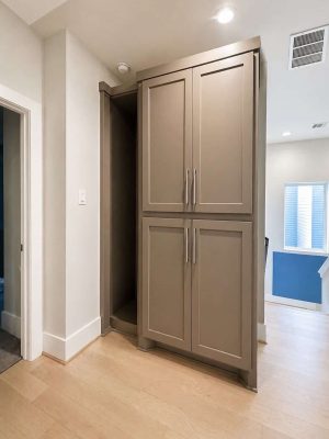 Detail view of painted shaker kitchen upper cabinets by SMPTR Design & Build