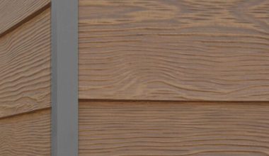 Winchester Brown RusticSeries wood-look composite siding on James Hardie fiber cement lap siding